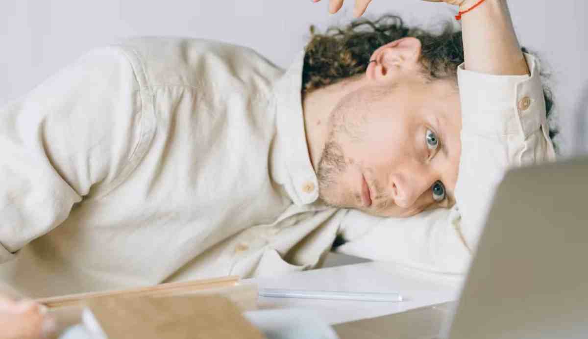 Man slumped at work desk