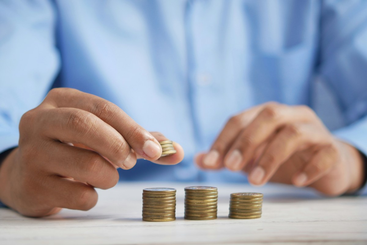 Analysis of Creative Australia data proves a useful litmus test in the health of the sector. Image is the torso of a man in a blue shirt counting piles of coins.