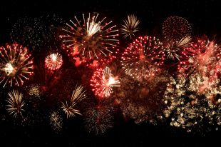 A burst of bright fireworks against a dark night sky.