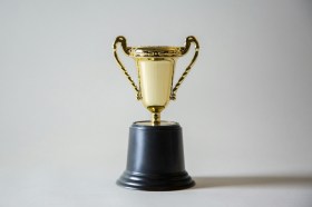 Picture of a gold trophy. Winner.