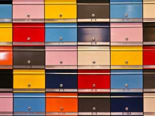 colour mailboxes in a tile grid pattern. Arts news.