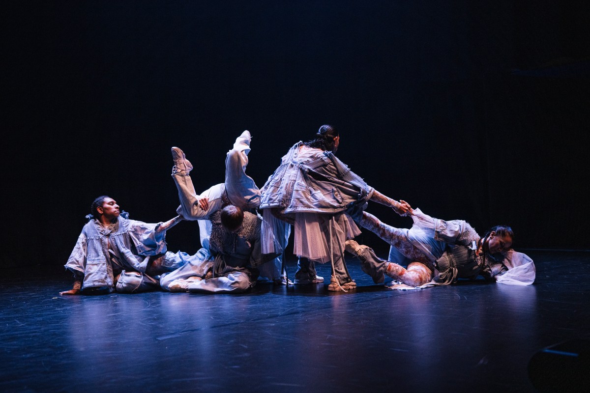 ‘MOUNTAIN: Clark x Melanie Lane’ at Melbourne Recital Centre for Now or Never 2024, featuring a group of five culturally diverse dancers dressed in heavy denim onstage. They are sitting with some lying on top of another and holding each other in challenging poses. 