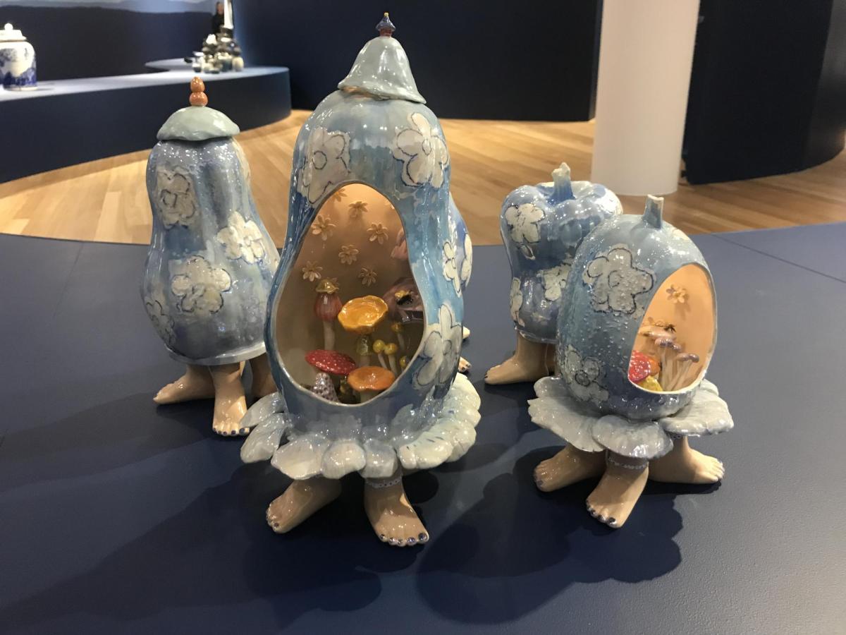 Five ceramic artworks in light blue. They each have legs on them. They are hollow, with toadstools inside.