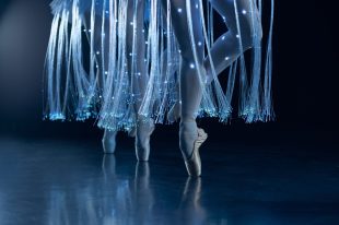 a close up of ballerinas' feet with lit up tutus. We Call it Ballet: Sleeping Beauty