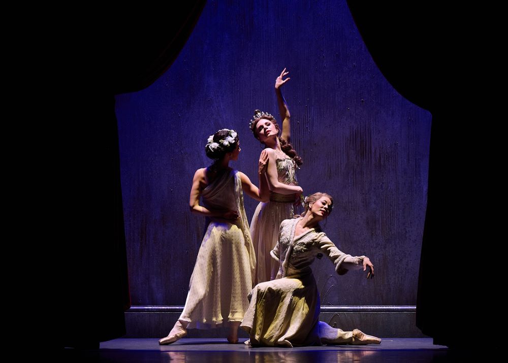 Mia Heathcote, Benedicte Bemet and Jill Ogai in The Australian Ballet's 'Oscar'. Three women, representing famous actresses of the day, pose dramatically on stage between parted curtains.