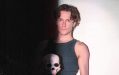 'Hamlet's Jacob Colins-Levy, a young man with brown hair and a black singlet carrying a skull.