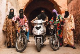 Image of African women wearing veils and bright patterned clothing on motobikes. Hassan Hajjaj.