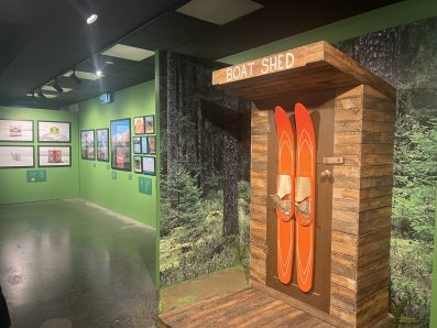 a pair of vintage water skis on a boat shed door in an exhibition. 'Accidentally Wes Anderson'