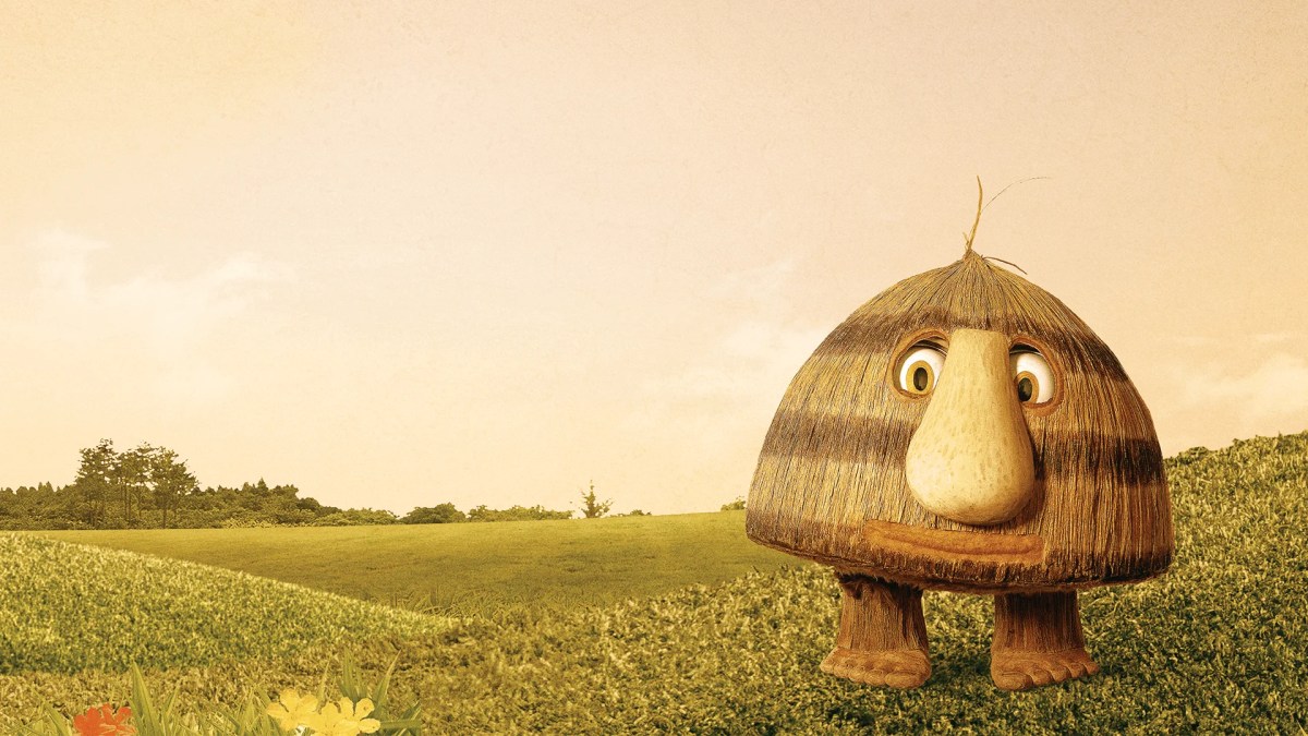 An illustrated picture of "Grug" standing in a field of grass. He is triangular shaped with feet and a large nose.