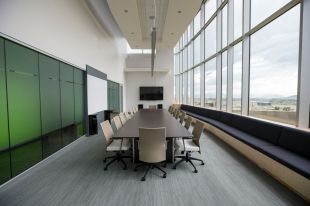 arts boards: an empty board meeting room with a central large table and 8 chairs.