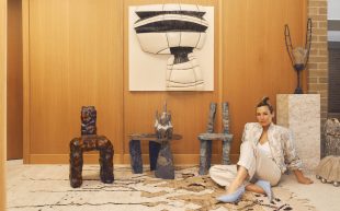 Simone Haag sitting down next to three crudely textured charis by Scotty Bemelen in her Melbourne home. She will curate the end of year exhibition at Craft Victoria.