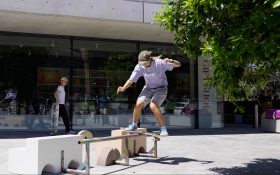 Skaters trying tricks on sculptures designed by Dr Sanné Mestrom. A skater trying to skate a rail outdoors on a sunny day.