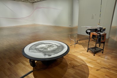 installation in gallery of machine with charcoal drawing on round marble. Dobell Biennial