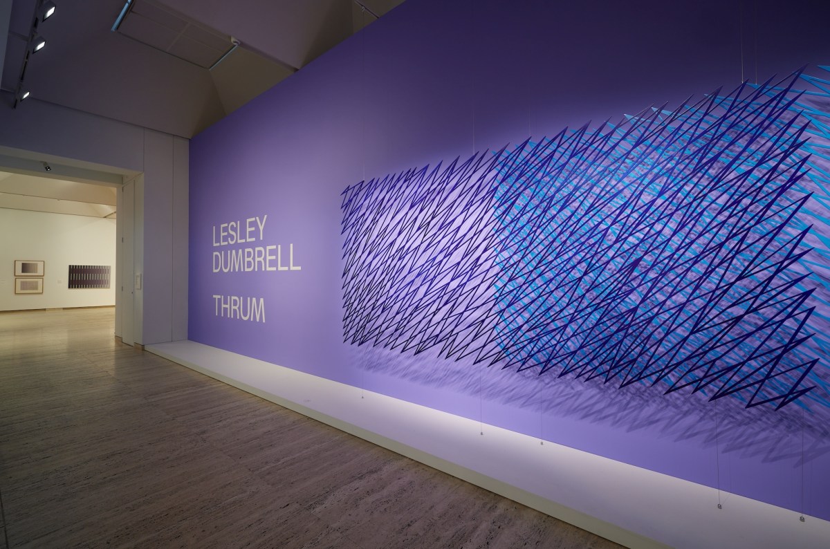 Purple coloured wall with abstract wall sculpture in blue Lesley Dumbrell