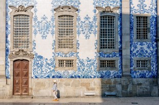 woman tourist viewing painted tiles on building in Portugal. Cultural tourism