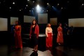 Four women are standing on stage wearing outfits of red, black and white. They are Elenoa Rokobaro, Zahra Neman, Ursula Yovich and Stefanie Caccamo i 'Well-Behaved Women.'.