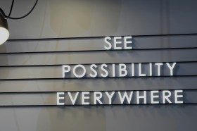 a grey sign that says "possibility everywhere"