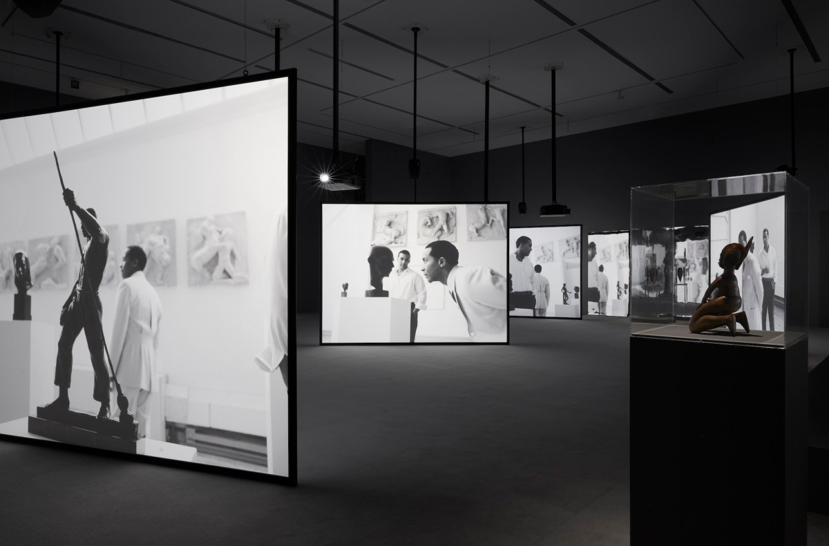 multi screen video in black and white of two African men in artist studio. Isaac Julien.