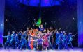 'Mary Poppins', one of the highest attended productions in Adelaide Festival Centre's 50-year history. A large group of lavishly dressed performers on stage, standing in a 'V' formation. The lights are blue/purple.