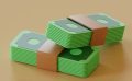 Two stacks of green cardboard tied up in a brown band made to look like money.