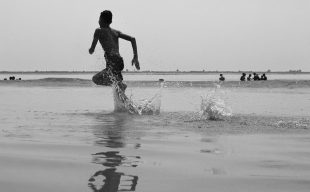 On the move is ArtsHub's weekly wrap of arts sector appointments and resignations. A black and white photo depicts a shirtless young man splashing through water as he runs along the beach.