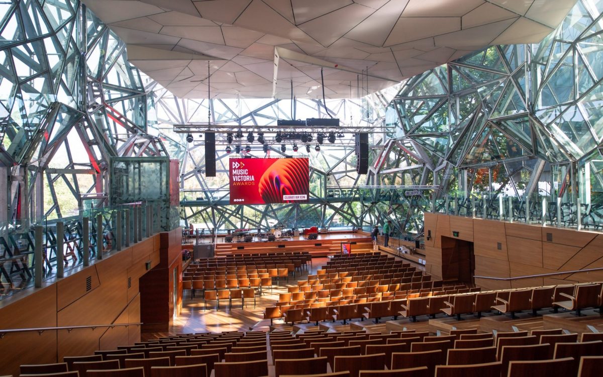 A "well-executed" act of voter fraud was detected for the 2024 Music Victoria Awards. A sun-filled lecture space with a screen displaying "MUSIC VICTORIA".