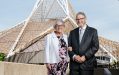 Jenny Leaper OAM and Dr John Leaper OAM. Two white elderly figures standing next to the Arts Centre Melbourne spire.