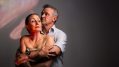 A man in a shirt clasps a woman from behind. Both look grim. Honour Red Stitch Actors' Theatre