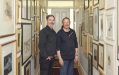 SAM Artistic Director Danny Lacy and Dr. Michael Elliott. Two white man standing in a narrow corridor filled with picture frames.