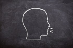 Image of a chalkboard head talking.