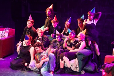 A group of young people wearing party hats sitting on or near a couch in 'Sweet Pea.'