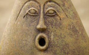 A photo of a sculptured object with a surprise expression on its face.