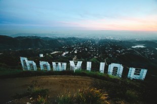 A view of the Hollywood sign from behind with landscape in distance. Actor painters.