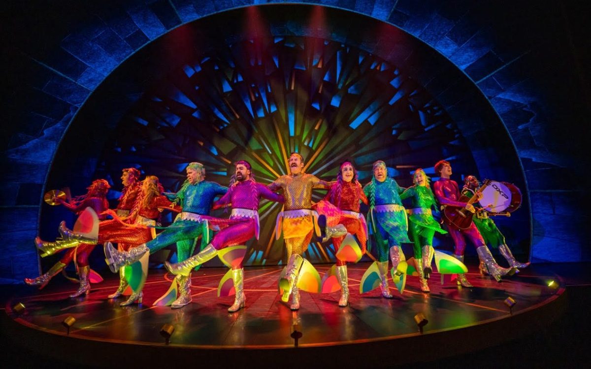 The 11 member cast of 'Peter and the Starcatcher' all in bright colourful costumes.