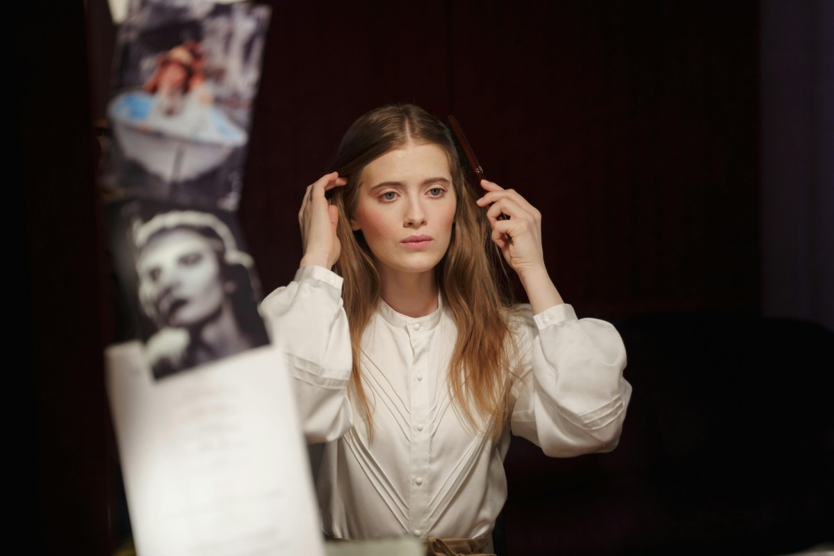 woman in white shirt in dressing room preparing for character acting. Monologue.