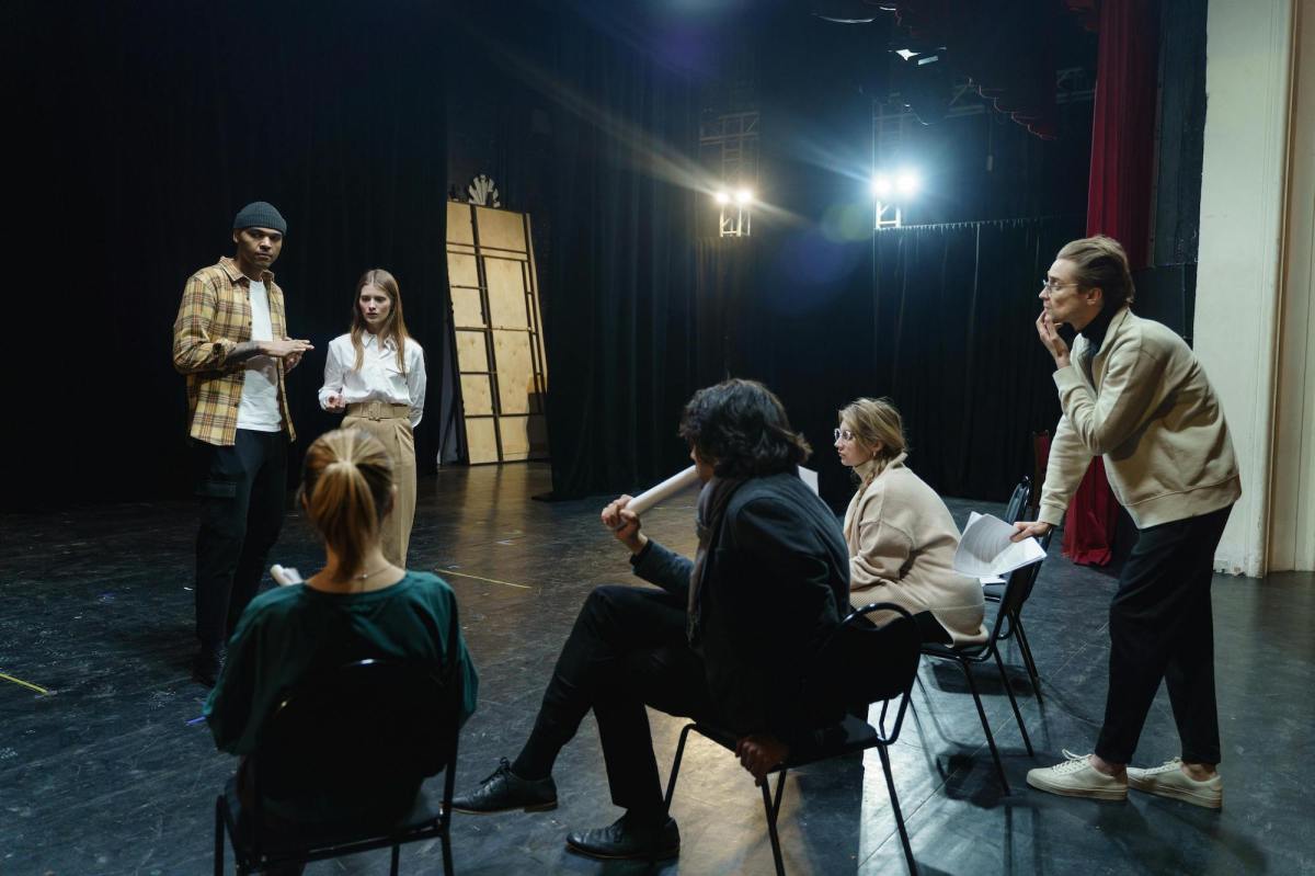 Group of people sitting around in an acting workshop.