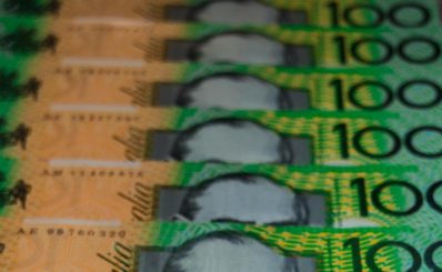 $3,880,000 over two years has been allocated to 12 small to medium companies in a new pilot program from Creative Australia. The photo is a close-up of multiple Australian $100 notes laid out and overlapping one another.