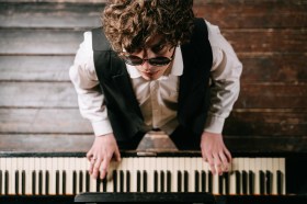 Blind man playing a keyboard piano. Disability Equity