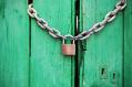 green timber door with chain and padlock. arts education