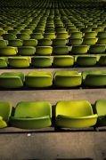 rows of empty green stadium seats