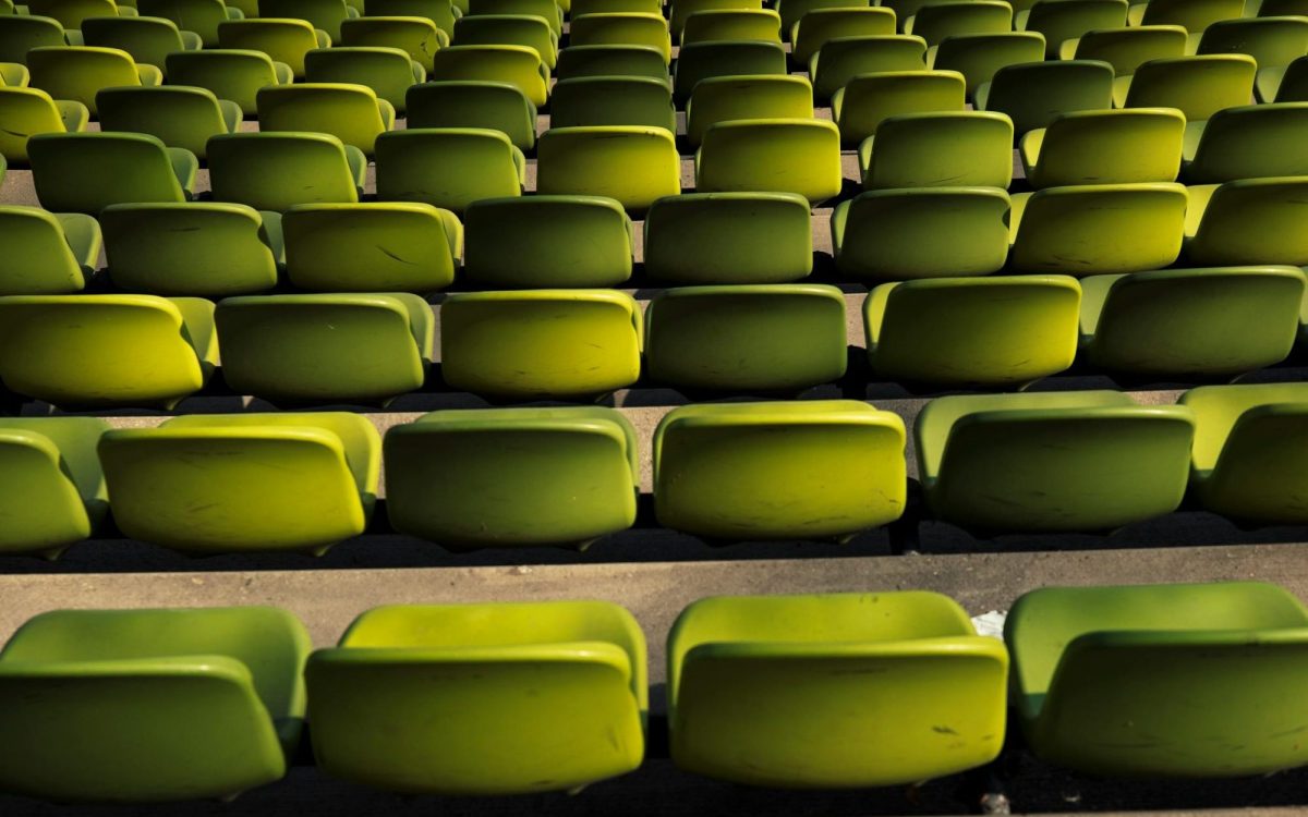 rows of empty green stadium seats