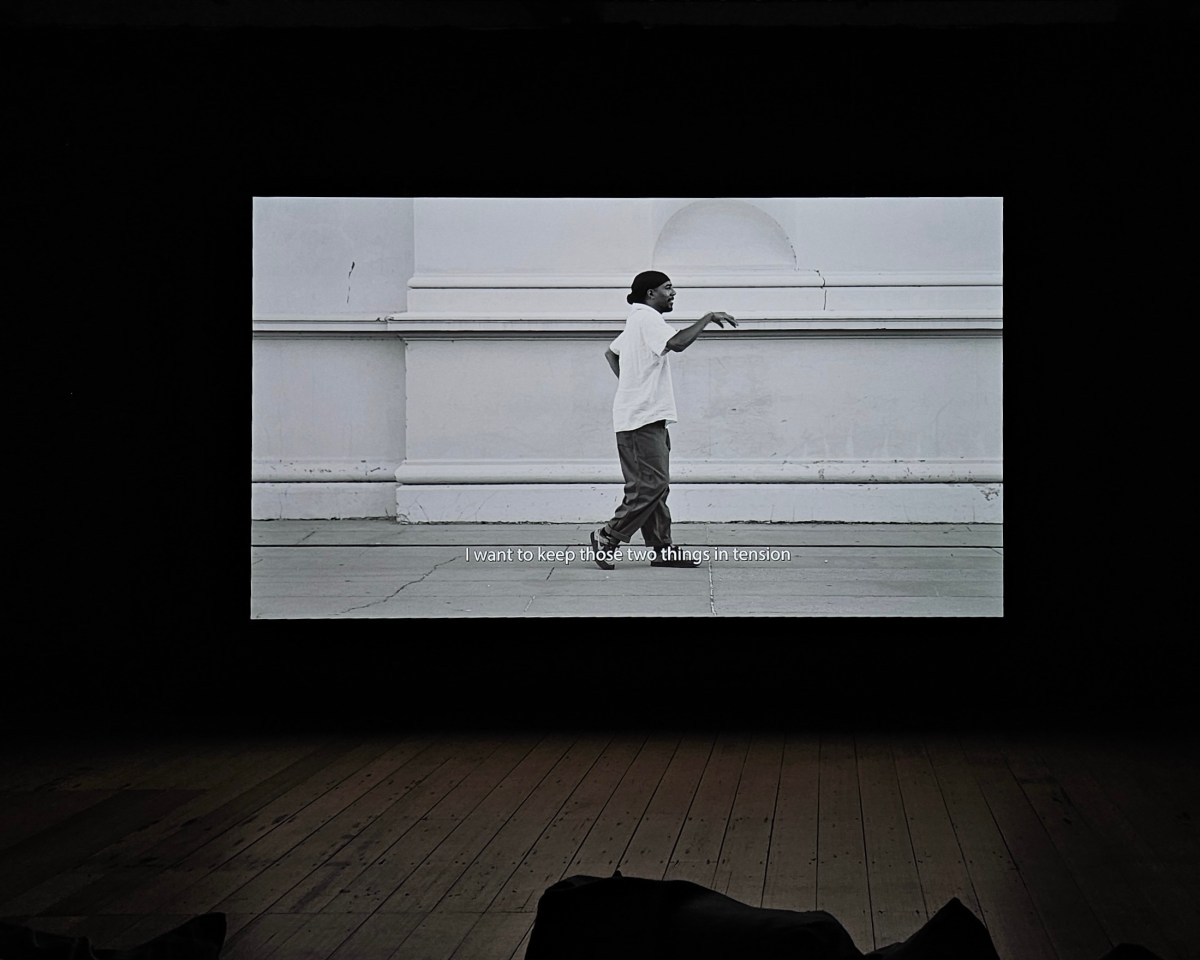 wani toaishara, ‘a most beautiful experiment’, installation view at West Space as part of PHOTO2024. A darkened room with a single channel video depicting a street dancer.