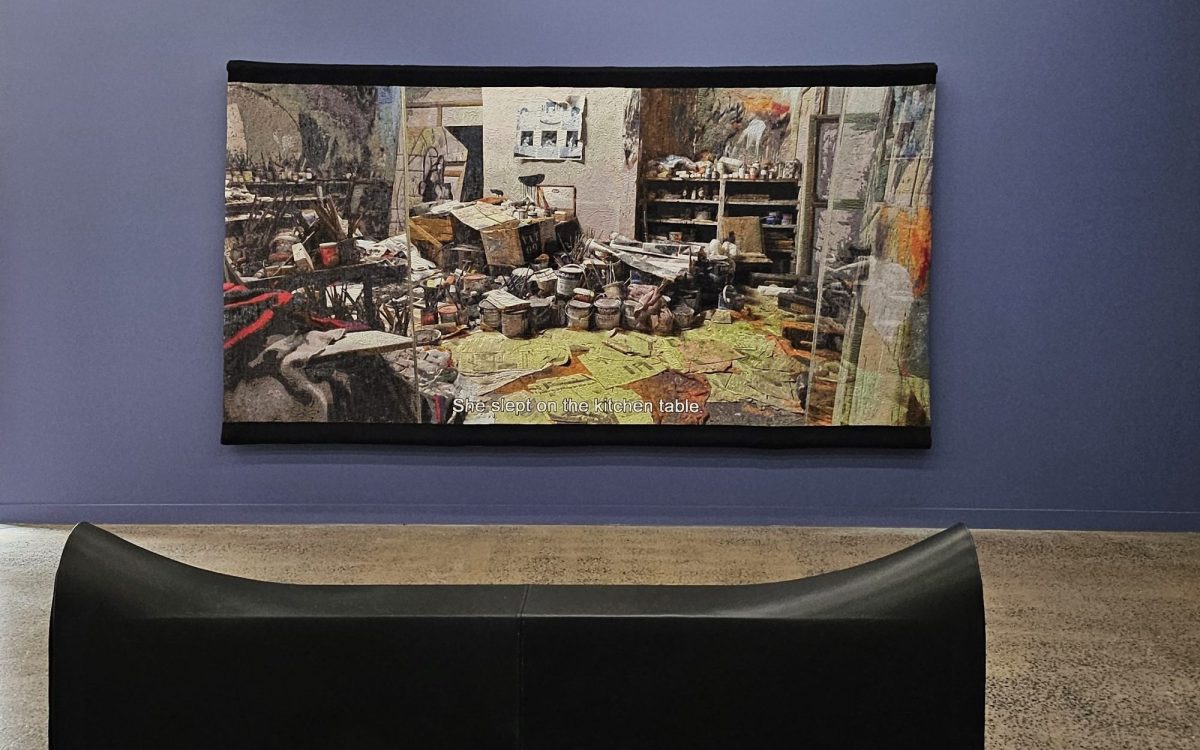 Best art. Claire Lambe, ‘Witnessing Bacon’, installation view at Sarah Scout Presents. A large tapestry based on a photo of Bacon’s messy studio, hanging against a violet wall with a saddle shaped seat in front.