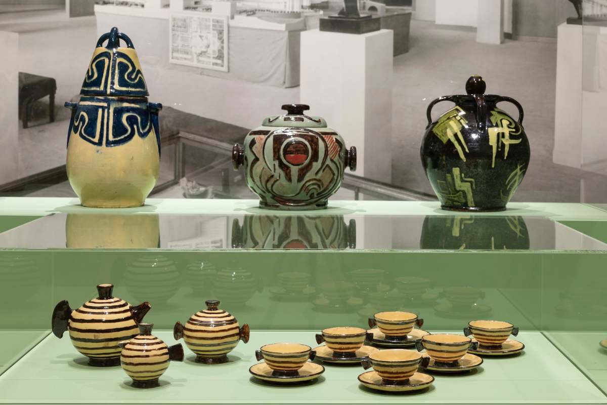 Gallery display of modern ceramics in display case painted green. Anne Dangar