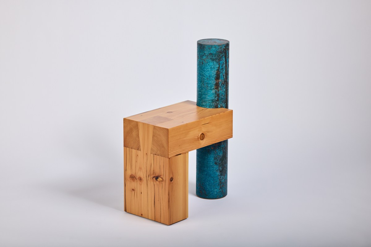 wooden chair with no arms but a blue copper circular pole as its back