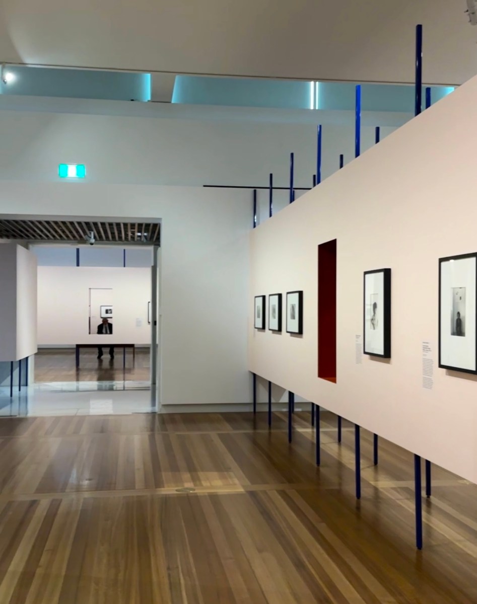 view of photographic exhibition with soft pink walls. Carol Jerrems