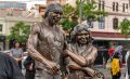 Uncle Archie Roach and Aunty Ruby Hunter have been immortalised in bronze in Fitzroy’s Atherton Gardens. The photo shows the two statues standing closely together and smiling.