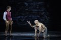 Rarmian Newton as Frodo Baggins and Laurence Boxhall as Gollum in 'Lord of The Rings - A Musical Tale'. Newton is dressed in a white shirt, red vest and brown knickerbockers. Boxhall is crouching and topless, wearing raggedy white pants. He is covered in white make-up with blood stains.