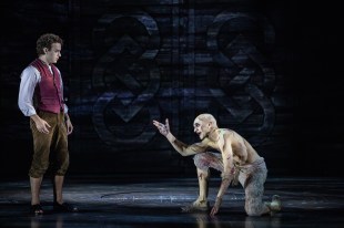 Rarmian Newton as Frodo Baggins and Laurence Boxhall as Gollum in 'Lord of The Rings - A Musical Tale'. Newton is dressed in a white shirt, red vest and brown knickerbockers. Boxhall is crouching and topless, wearing raggedy white pants. He is covered in white make-up with blood stains.