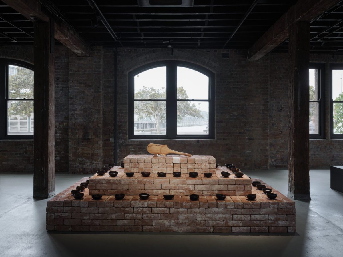 A pyramidal structure consisting of bricks and small bowls.